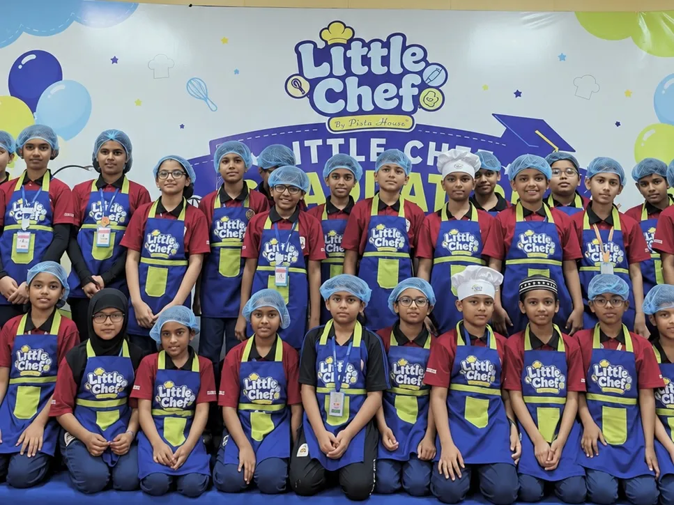 A school group of Little Chefs at the graduation stage